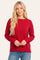 woman wearing a red long sleeve sweater with a relaxed fit and crew neckline, paired with blue jeans