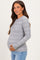 woman wearing a gray striped maternity sweater and showing her baby bump