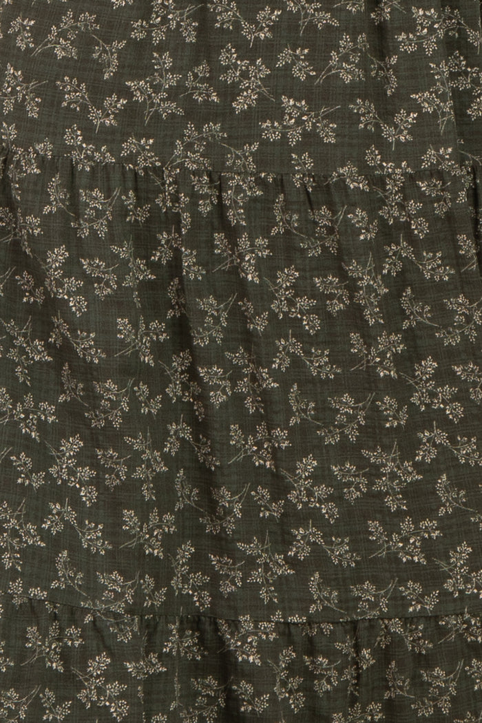 dark green floral tiered dress with subtle patterns and ruffled layers