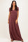 woman wearing a burgundy short sleeve maxi dress with wrap detail and flowing skirt