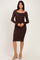 woman wearing a brown long sleeve fitted lace dress with a square neckline and mid-length hemline
