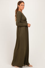 woman wearing a long sleeve olive green maxi dress with a twist front detail