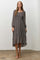 woman wearing a gray floral long sleeve midi dress with a square neckline and ruffled hem