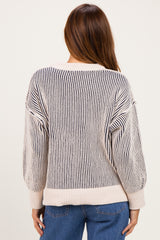 woman wearing a striped navy and cream oversized sweater from the back with balloon sleeves and relaxed fit