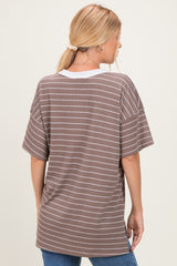 woman wearing a brown and white striped oversized t-shirt from the back, styled with loose sleeves