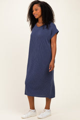 woman wearing a navy blue striped oversized t-shirt dress with short sleeves and white sneakers
