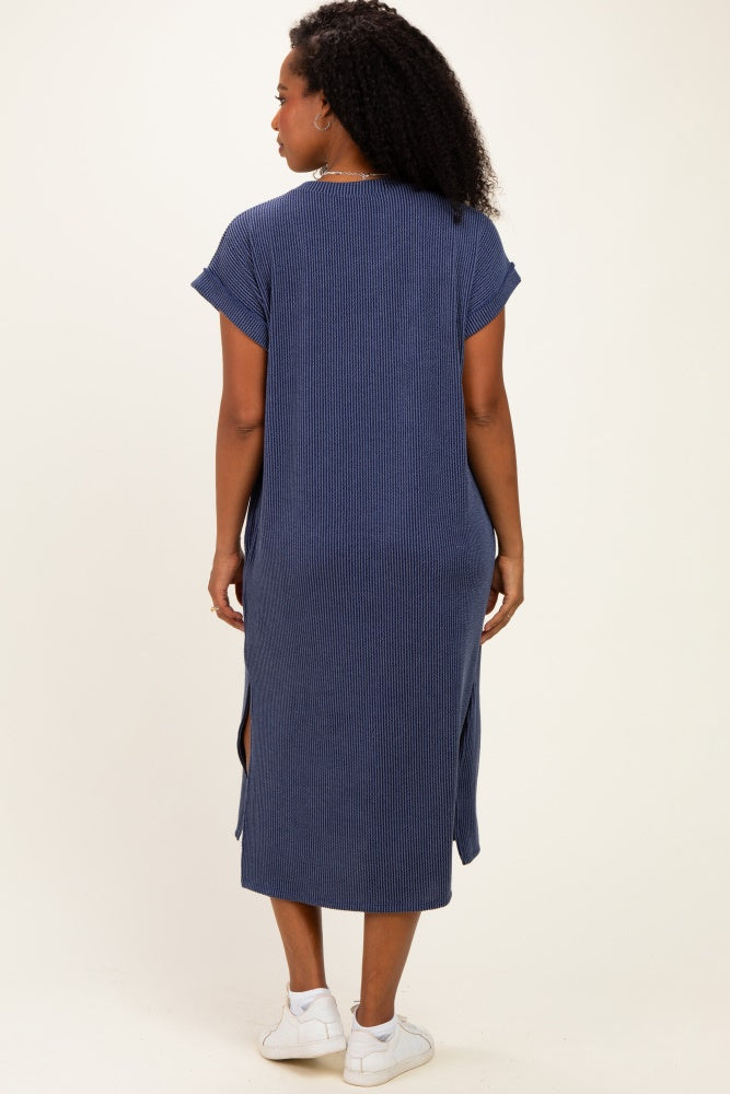 woman wearing a navy blue striped maxi dress with short sleeves and side slits, seen from the back