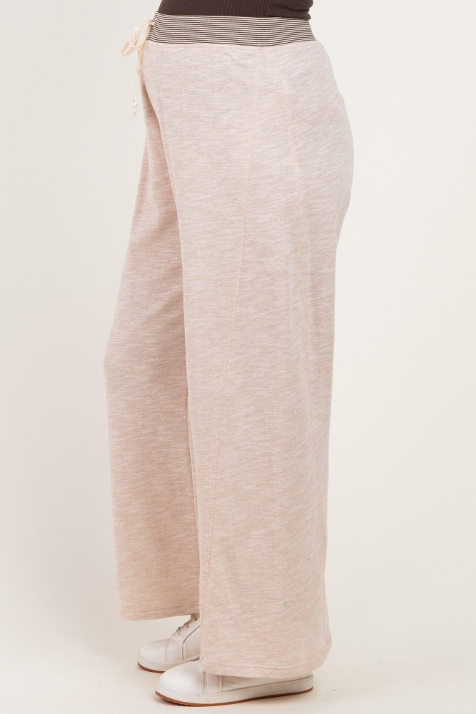 woman wearing light pink wide-leg maternity sweatpants with a drawstring waistband