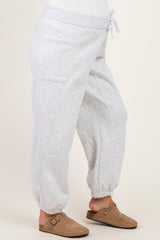 woman wearing light gray maternity sweatpants with a drawstring waist and tapered cuffs
