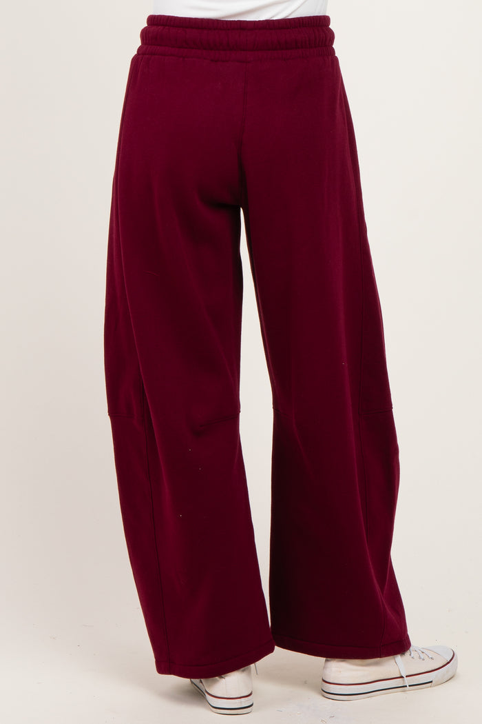 woman wearing burgundy wide-leg pants with an elastic waistband and back pockets