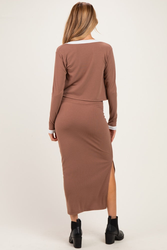woman wearing a brown maternity midi dress with a fitted style and side slit, showing a baby bump from the back