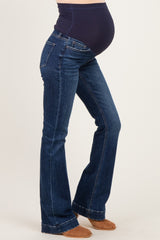 woman wearing dark blue maternity bootcut jeans with a supportive belly panel and a visible baby bump