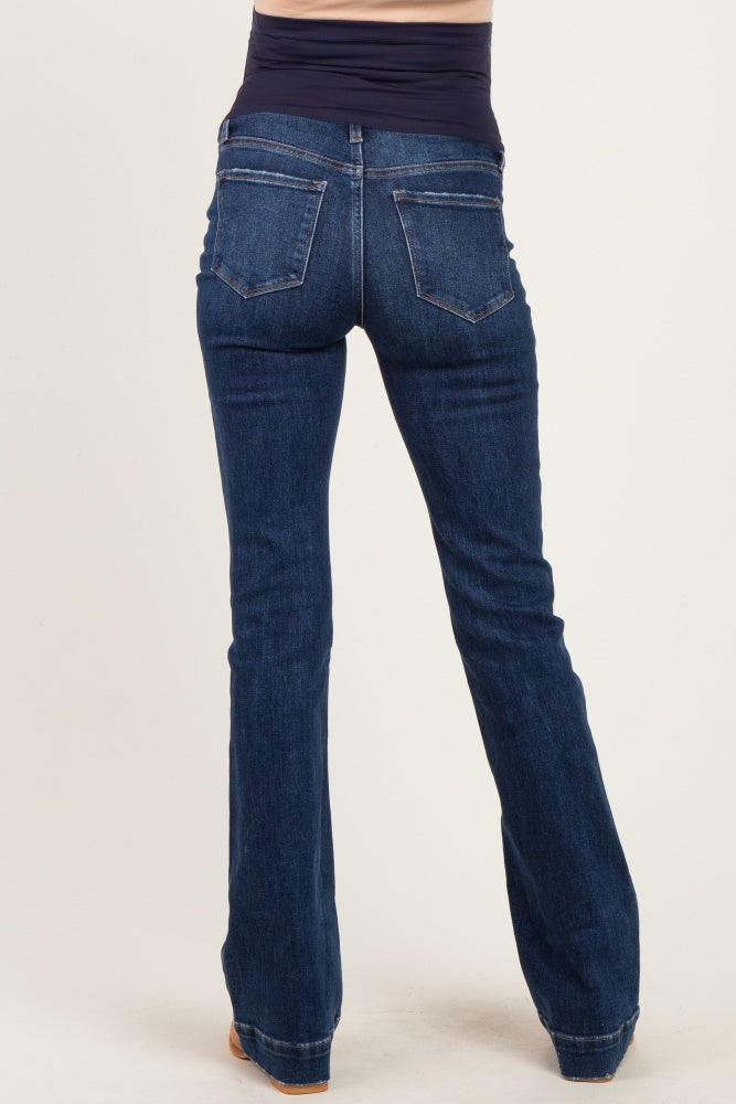 woman wearing dark wash flared maternity jeans with a high waistband from the back