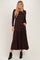 woman wearing a brown long sleeve tiered maxi dress with pockets and black ankle boots