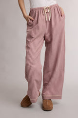 woman wearing pink striped lounge pants with an elastic waistband and drawstring, features side pockets
