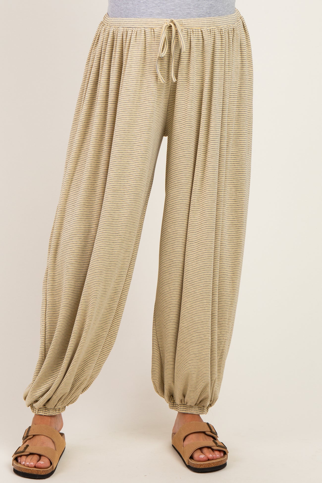 maternity wear beige striped harem pants with an elastic waistband and cuffs, styled with a casual top and sandals