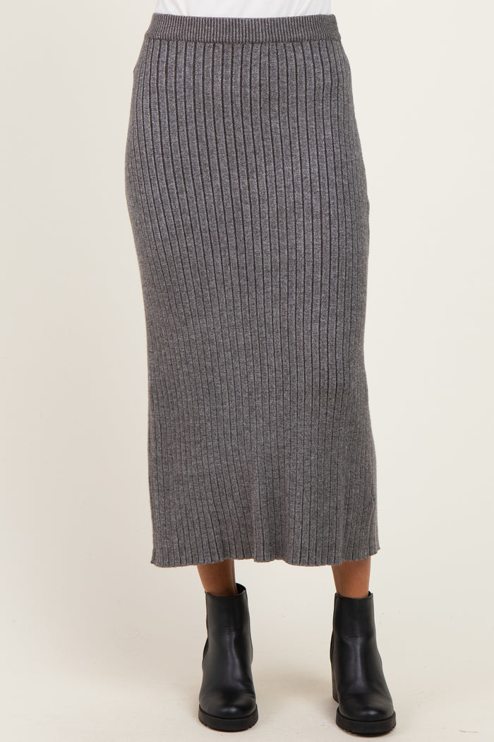 woman wearing a gray ribbed knitted midi skirt paired with black ankle boots