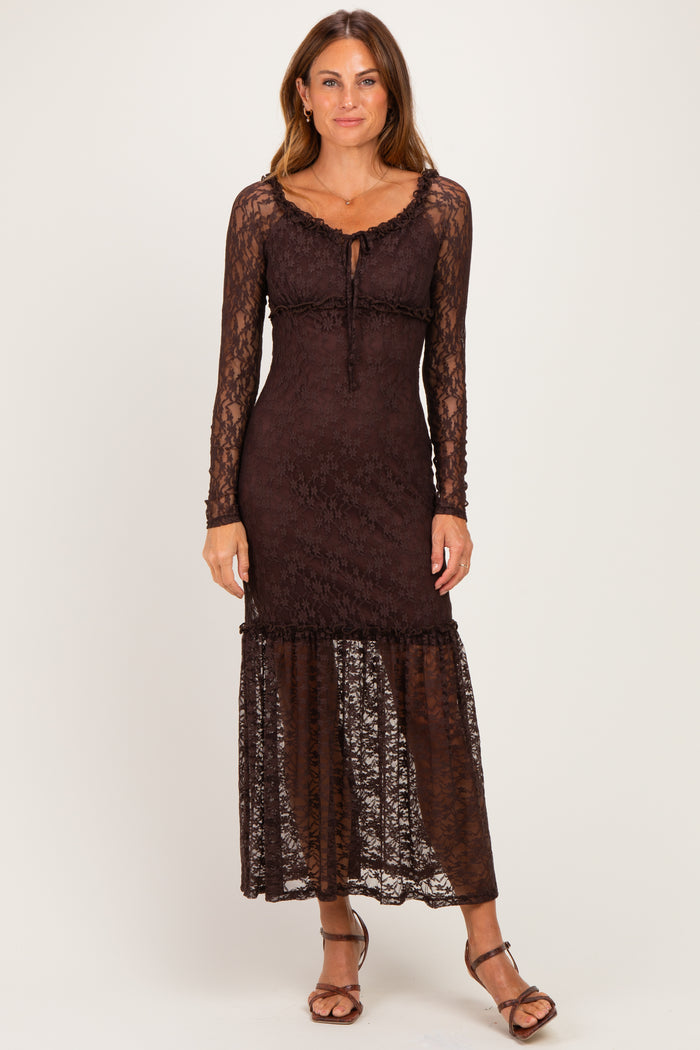 woman wearing a brown lace long sleeve maxi dress with a ruffled hem and a fitted bodice