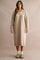 woman wearing a beige long sleeve zip-up sweater dress with ribbed details and a relaxed fit