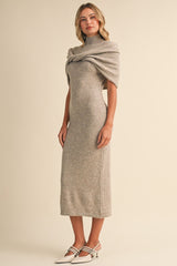 woman wearing a gray midi dress with a high neck and draped detailing, paired with stylish heels