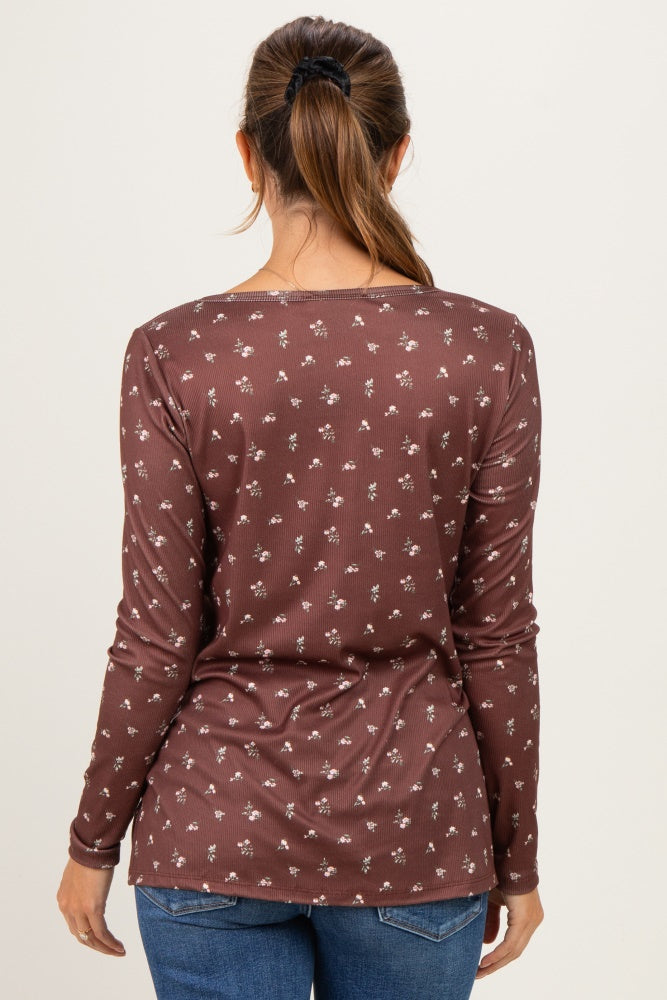 woman wearing a brown long sleeve maternity top with a floral pattern, viewed from the back