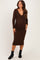 woman wearing a brown long sleeve maternity dress with a v-neckline and ruching at the baby bump