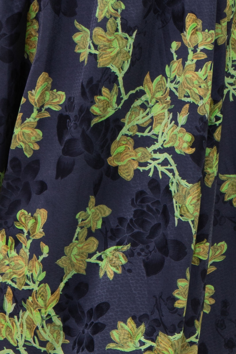 navy blue dress with vibrant green floral pattern and delicate pleats