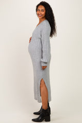 woman wearing a light gray ribbed maternity dress with side slits and a visible baby bump