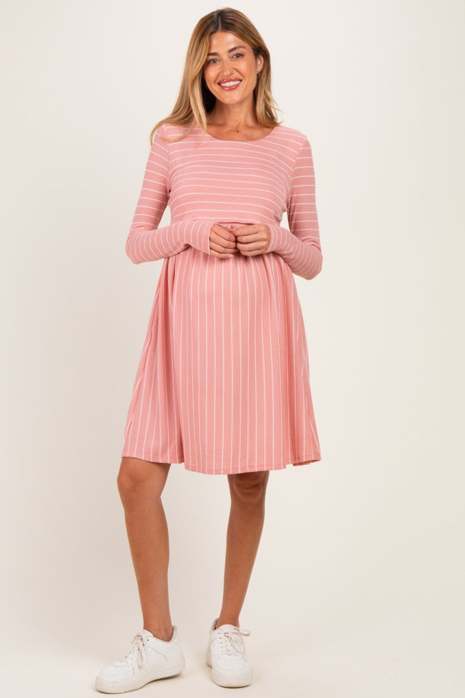 woman wearing a pink striped long sleeve maternity dress with a flowy fit and visible baby bump