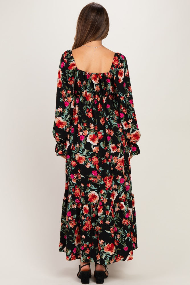 woman wearing a black floral maternity maxi dress with long sleeves and a square neckline, viewed from the back