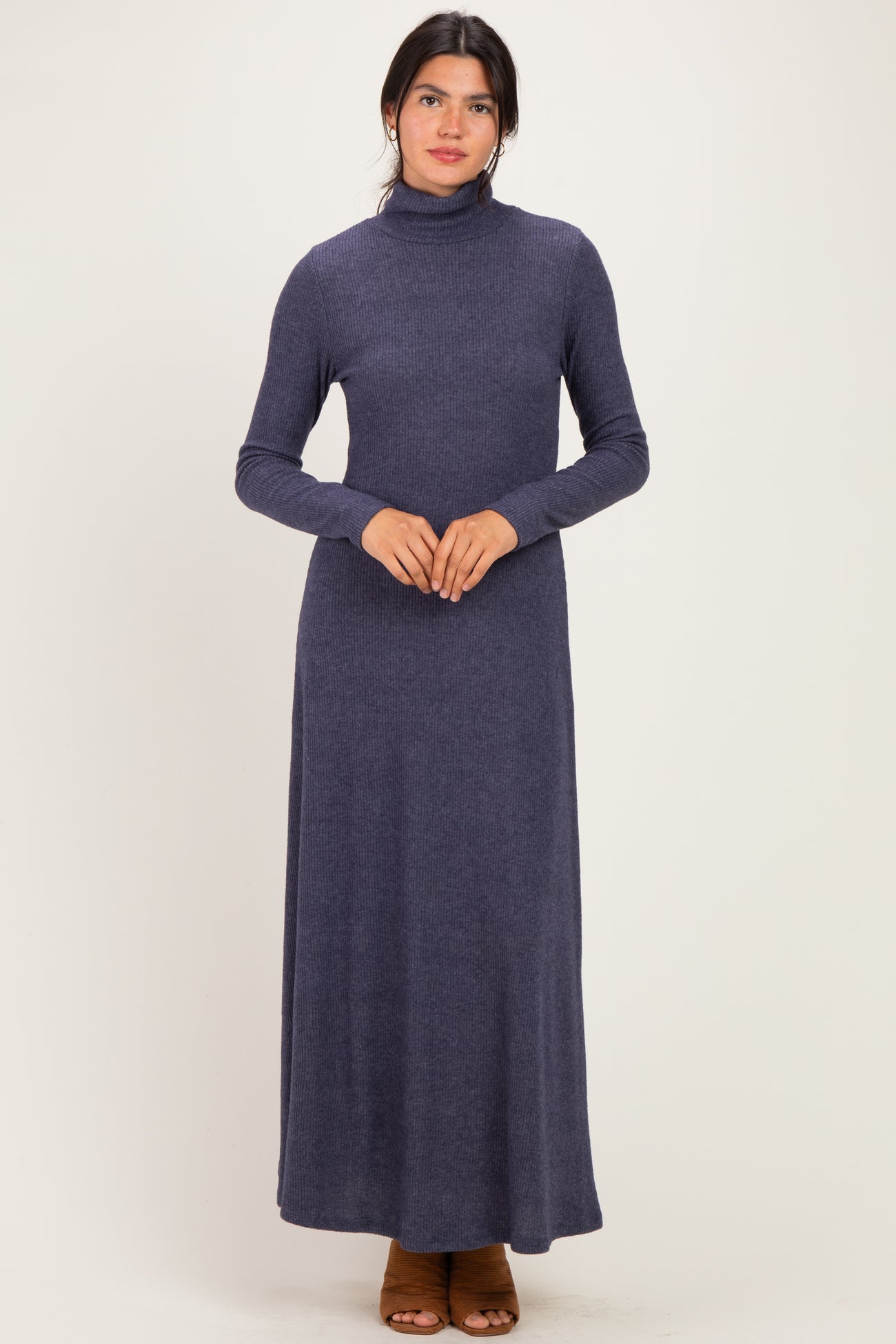 woman wearing a dark blue long sleeve turtleneck maxi dress
