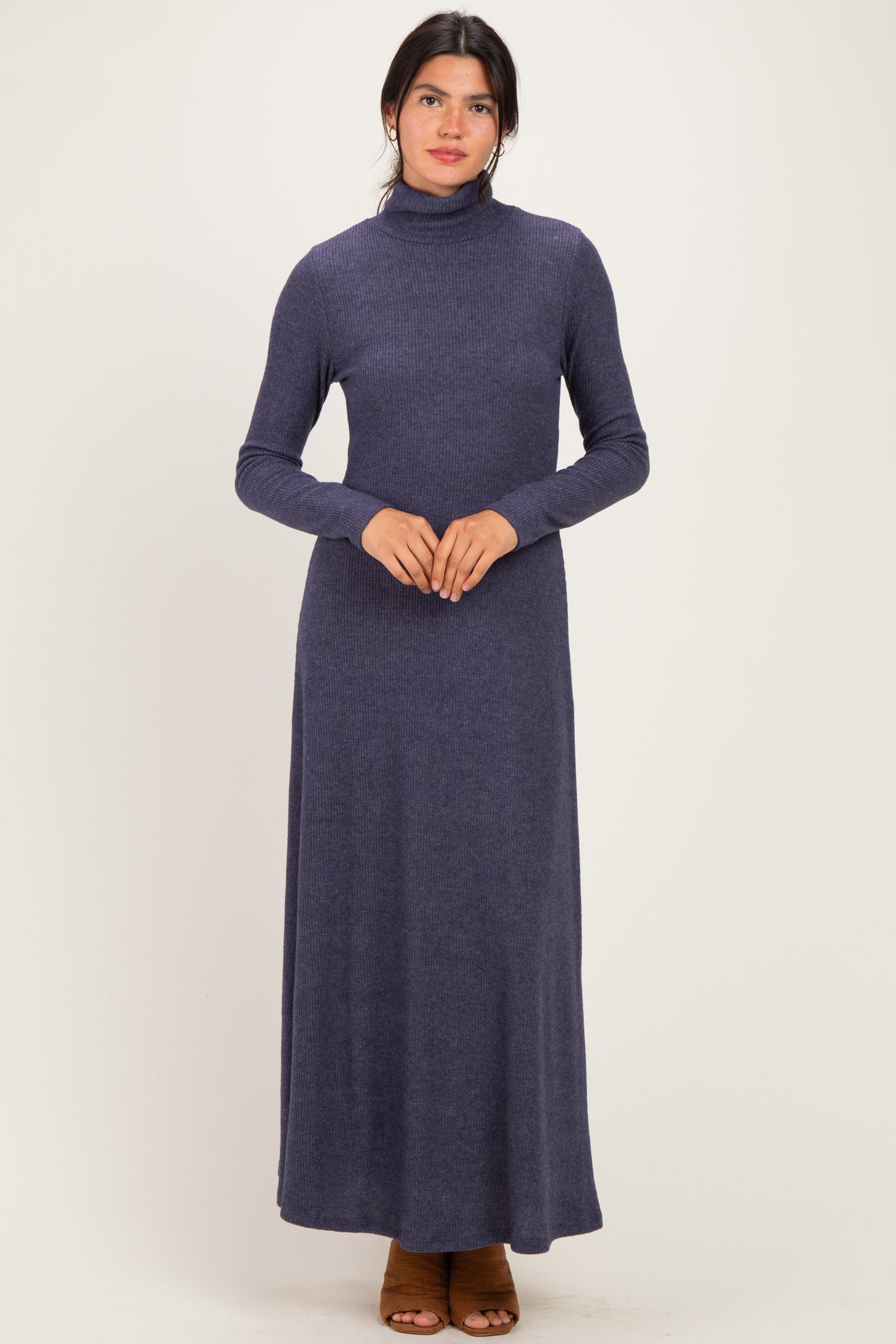 woman wearing a dark blue long sleeve turtleneck maxi dress