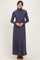 woman wearing a dark blue long sleeve turtleneck maxi dress
