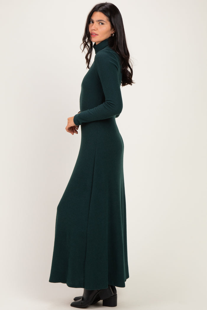 woman wearing a dark green long sleeve turtleneck maxi dress, standing sideways