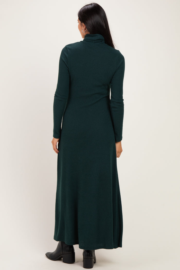 woman wearing a dark green ribbed maxi dress with a high neckline and long sleeves, shown from the back