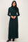 woman wearing a green turtleneck maternity dress that falls to the floor, styled with long sleeves and a relaxed fit