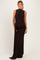 woman wearing a brown sleeveless maternity gown with a side drape and a visible baby bump