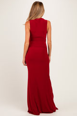 woman wearing a form-fitting red maternity gown, showing silhouette from the back