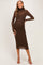 woman wearing a chocolate brown long sleeve maternity dress with a form-fitting design and turtleneck detail, showcasing her baby bump