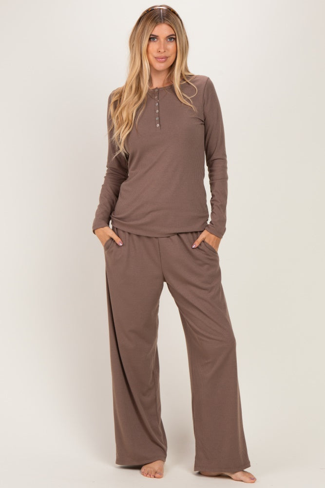 woman wearing a brown long sleeve henley top and matching wide-leg pajama pants