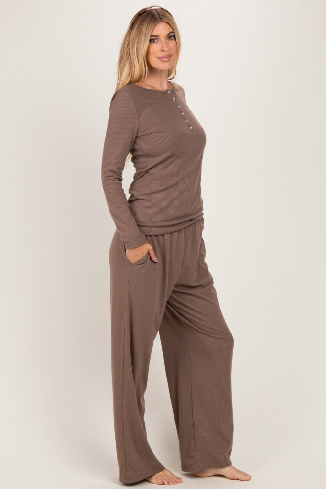 woman wearing a brown long sleeve henley top and matching wide-leg pants
