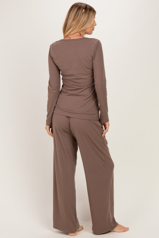 woman wearing a brown long sleeve loungewear set with loose fitting pants and top, viewed from the back
