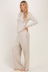 woman wearing a light beige long sleeve top and matching wide-leg pants in a ribbed texture