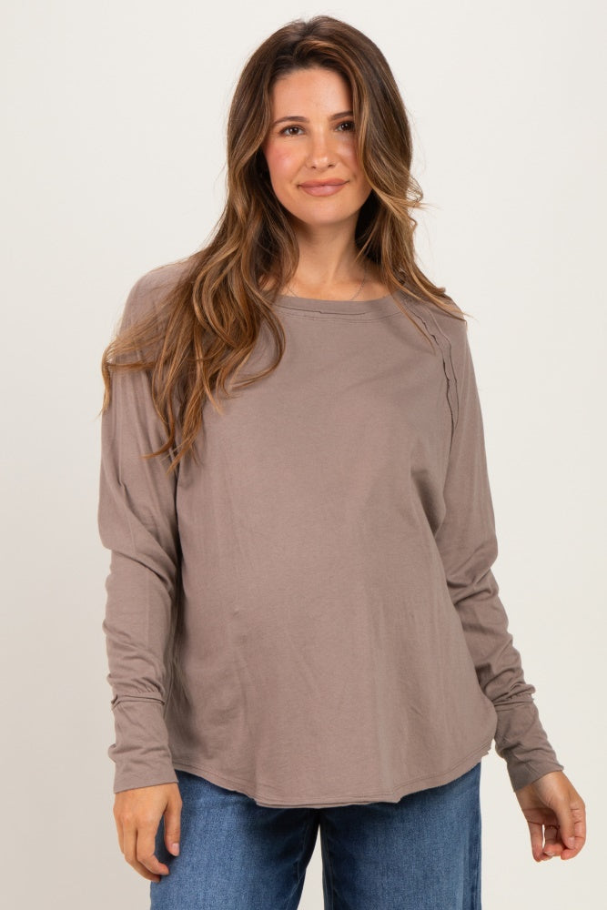 woman wearing a taupe long sleeve maternity top with a relaxed fit and side ruching