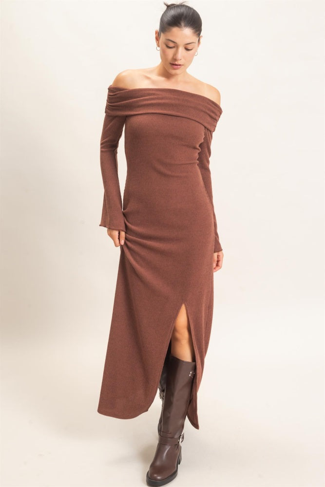 woman wearing a brown off-the-shoulder ribbed maxi dress with a side slit and long sleeves
