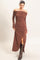woman wearing a brown off-the-shoulder ribbed maxi dress with a side slit and long sleeves