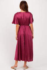 woman wearing a burgundy pleated midi dress with flutter sleeves, viewed from the back