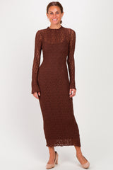 woman wearing a brown long sleeve lace maxi dress with a fitted silhouette and a high neckline