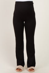 woman wearing black maternity workout leggings with a high waistband and a comfortable fit