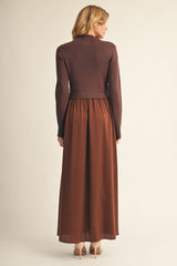 woman wearing a brown ribbed crop top over a flowy brown maxi dress, viewed from the back